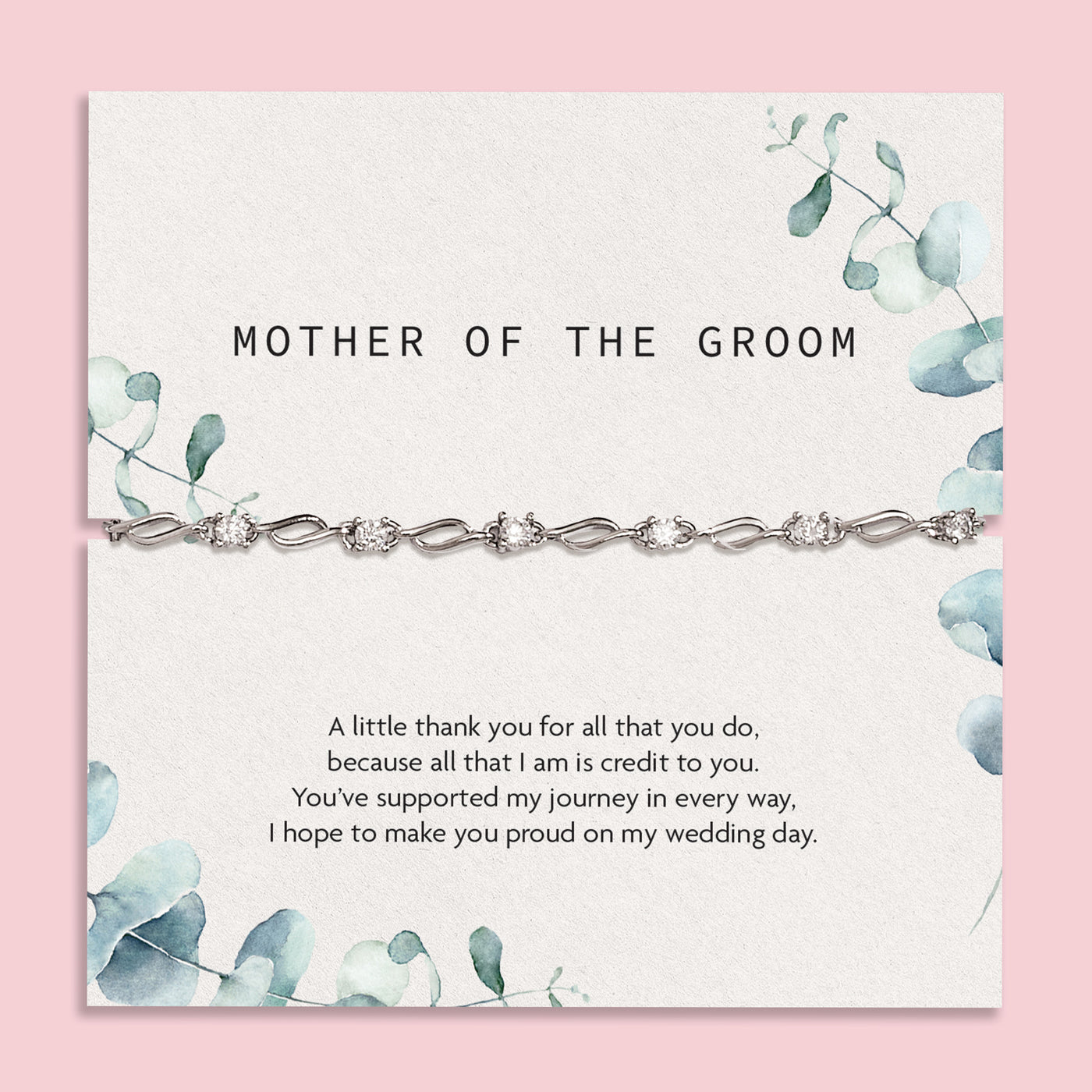 Elegant 'Mother of the Groom' card set against a silky white fabric backdrop. The card, adorned with soft blue floral designs, expresses gratitude and appreciation with a heartfelt message. Draped over the card is a sophisticated silver bracelet with intricate detailing. 