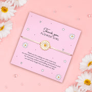Thank You Flower Girl bracelet with daisy charm on adjustable white cord, displayed with pink background and floral accents, featuring a heartfelt message for flower girls.