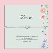 Delicate silver heart charm bracelet displayed on a pastel floral thank you card with the message “This little bracelet is to say thank you for all that you do.” Meaningful thank you gift for friends, teachers, bridesmaids or loved ones.