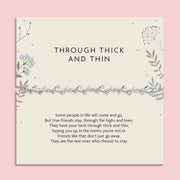 Silver leaf vine friendship bracelet displayed on a neutral floral illustrated card reading “Through Thick and Thin” with a sentimental friendship poem underneath.