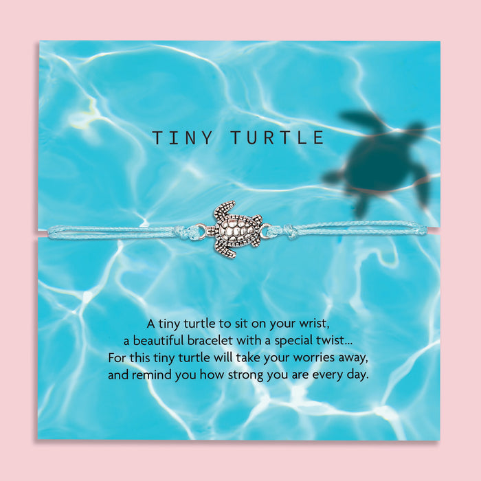 A turquoise bracelet with a small silver turtle charm, displayed on a card with a water-themed background. The card reads: 'Tiny Turtle. A tiny turtle to sit on your wrist, a beautiful bracelet with a special twist... For this tiny turtle will take your worries away and remind you how strong you are every day.' At the top, the brand name 'Letterbox Love' is shown with the tagline 'Posting Positivity