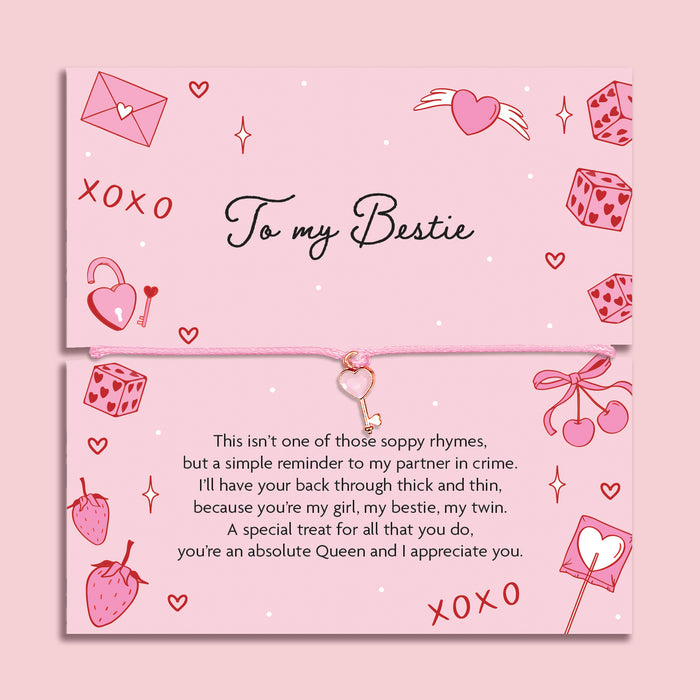 Poem card with decorative elements and text about friendship on a pink background. The Bracelet is a pink key friendship bracelet