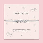 Silver Bows charm bracelet on a pastel pink card with the message "True Friend";  a thoughtful friendship gift for women featuring an adjustable cord and heartfelt poem.