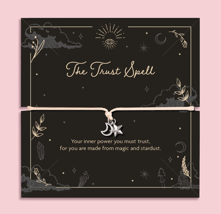 Moon and star charm bracelet on adjustable cord displayed on black celestial Trust Spell affirmation card with mystical symbols, spiritual jewellery gift.