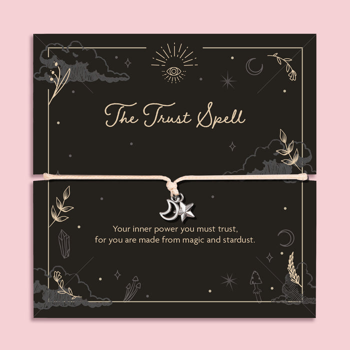 Moon and star charm bracelet on adjustable cord displayed on black celestial Trust Spell affirmation card with mystical symbols, spiritual jewellery gift.