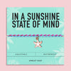 Turquoise, pink and blue waterproof anklet duo with enamel starfish charm displayed on an aqua 
