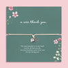 Silver heart and flower charm bracelet on an adjustable cord displayed on a green floral card featuring the Scottish phrase “a wee thank you”. Meaningful thank you gift for friends, teachers, coworkers or loved ones.