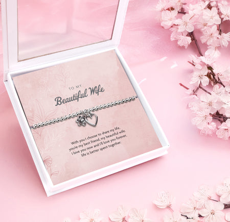 A silver-plated beaded bracelet with a heart and flower charm displayed in a premium keepsake box. The box includes a pink backing card with the message 