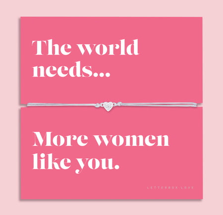 Friendship bracelet with a silver heart charm on an adjustable cord, displayed on a pink card reading “The world needs… more women like you” — an empowering bracelet for a friend and thoughtful friendship gift by Letterbox Love.