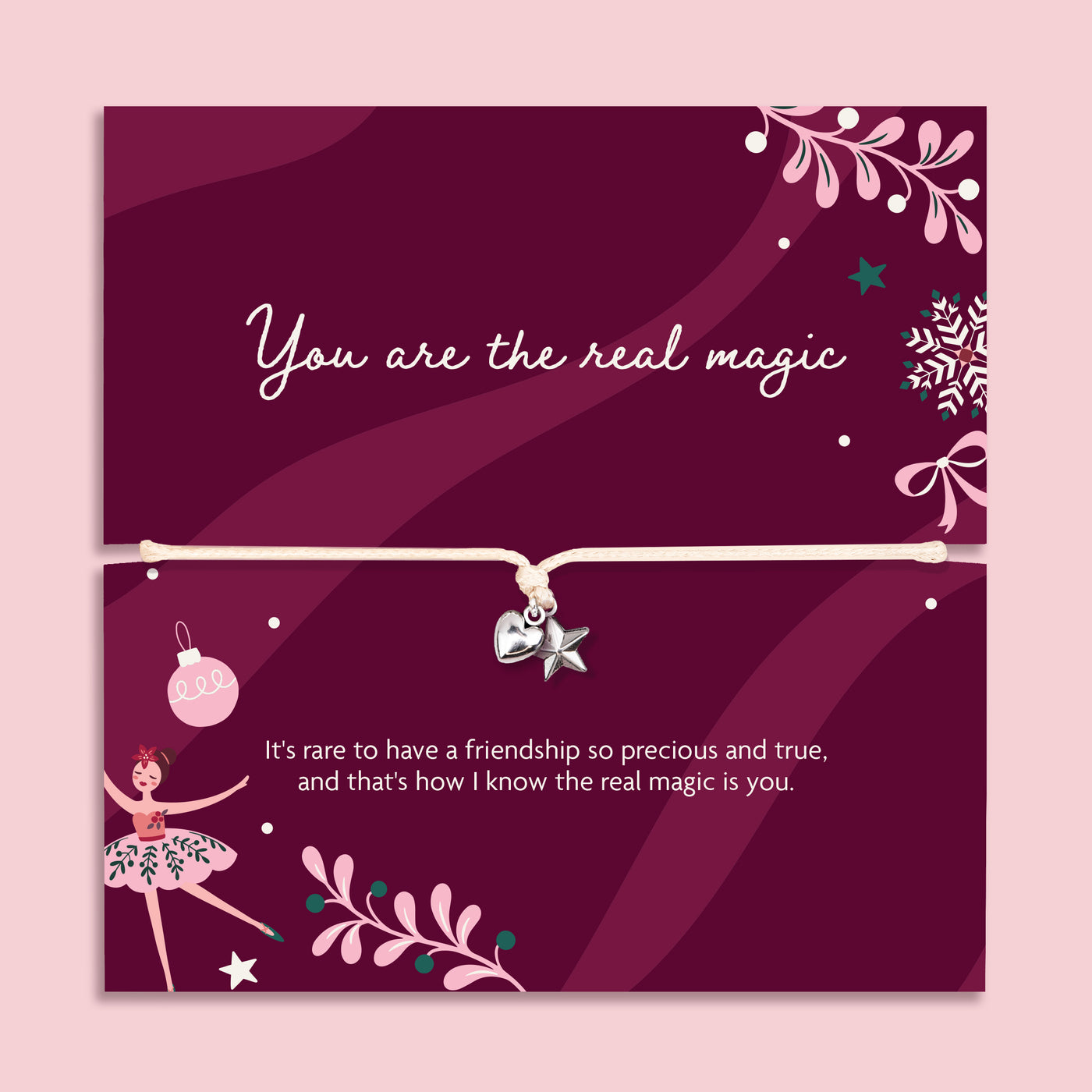 A square pink card with a thin cord bracelet across the center, decorated with white text, ballerina illustrations, stars, and floral motifs on a dark magenta background. A heartfelt gift for Xmas.