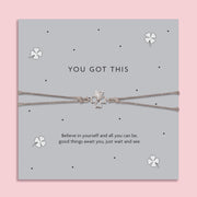 You Got This good luck bracelet with silver four leaf clover charm on grey adjustable cord, displayed on motivational card, encouragement gift for exams and students