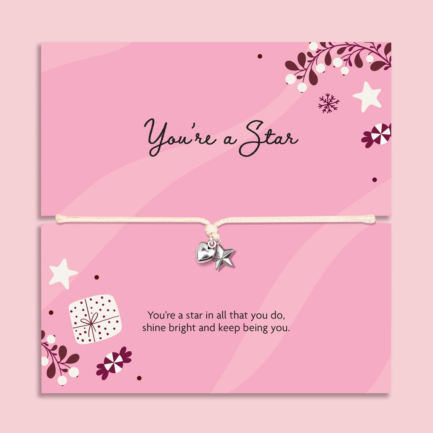Pink card bracelet gift set with a silver heart and star charm on a cord, shown in two stacked cards with decorative stars, flowers, and inspirational text. The card reads 'you're a star', a heartfelt gift for her this Christmas