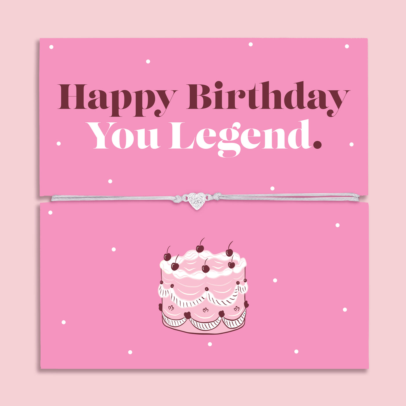 Happy Birthday You Legend bracelet with heart charm on adjustable cord displayed on pink birthday card with cake illustration, fun birthday gift