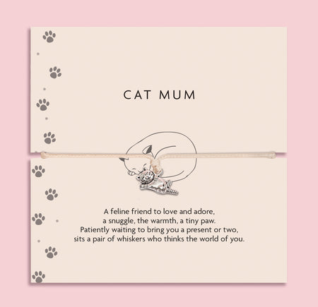Cat-themed bracelet on a card with paw prints and text on a pink background