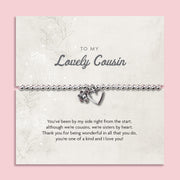 A silver beaded bracelet with a heart and flower charm displayed on a card reading "To my Lovely Cousin" from Letterbox Love, set against a soft pink background. The card features a heartfelt poem, making it an ideal sentimental gift for a cousin.