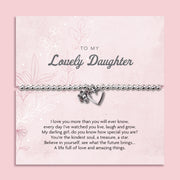 A silver beaded bracelet with a heart and flower charm displayed on a card reading "To my Beautiful Daughter" from Letterbox Love, set against a soft pink background with delicate flowers. The card features a heartfelt message, making it a thoughtful gift for a daughter.