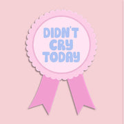 Pink badge with 'Didn't Cry Today' badge sticker on a light pink background. Ideal for journals or water bottles.