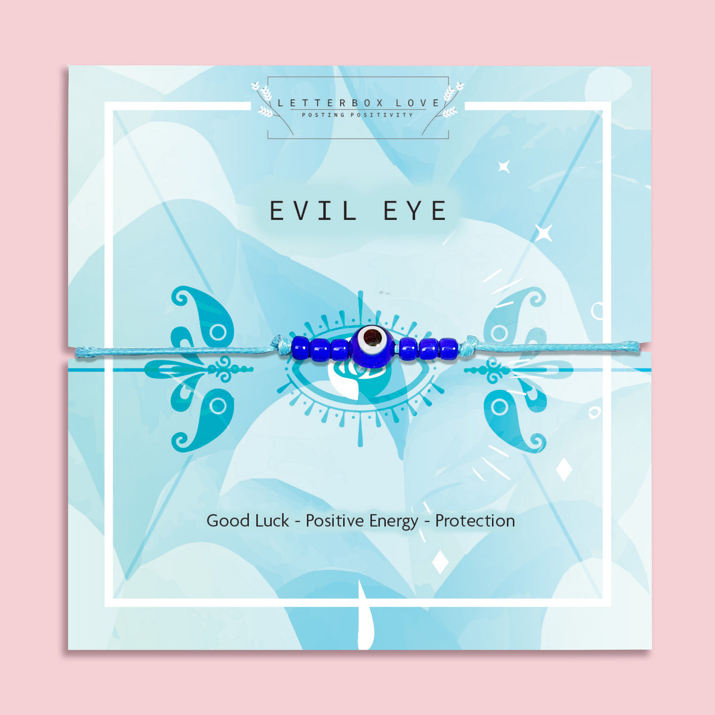 a pink background with a blue 'evil eye' poem card. the bracelet is a blue beaded evil eye charm for good luck and positivity.
