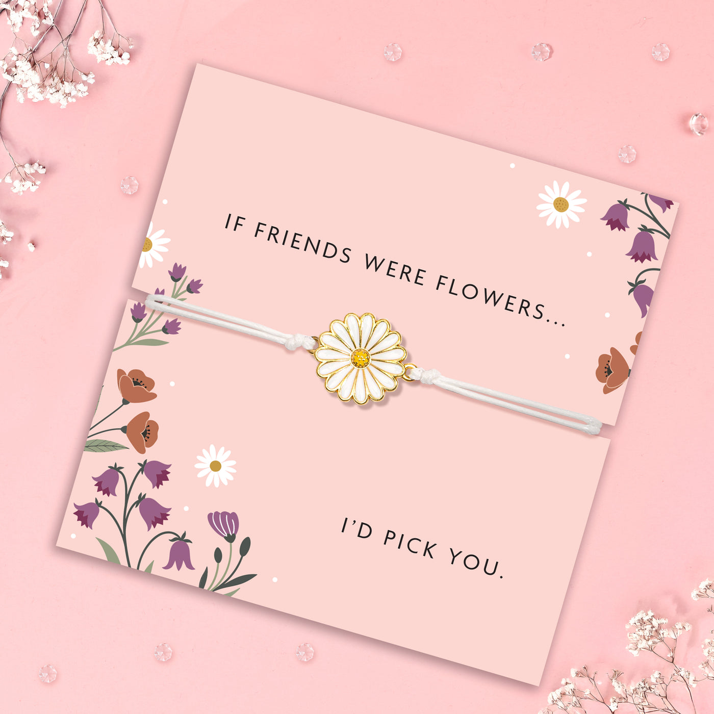 Floral-themed card with a daisy charm bracelet on a pink background. Gypsophila surrounds the card.