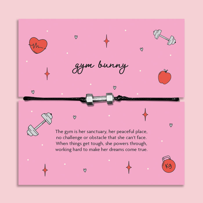 Adjustable black cord Gym Bunny bracelet with silver dumbbell charm displayed on pink motivational fitness message card, workout and gym gift for her.