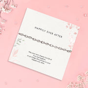 a wedding gift wishing a 'happily ever after', a heartfelt poem card and silver-plated and cubic zirconia bracelet gift with white flowers scattered round