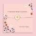 White adjustable friendship bracelet with a white enamel daisy flower charm displayed on a pink floral sentiment card reading 