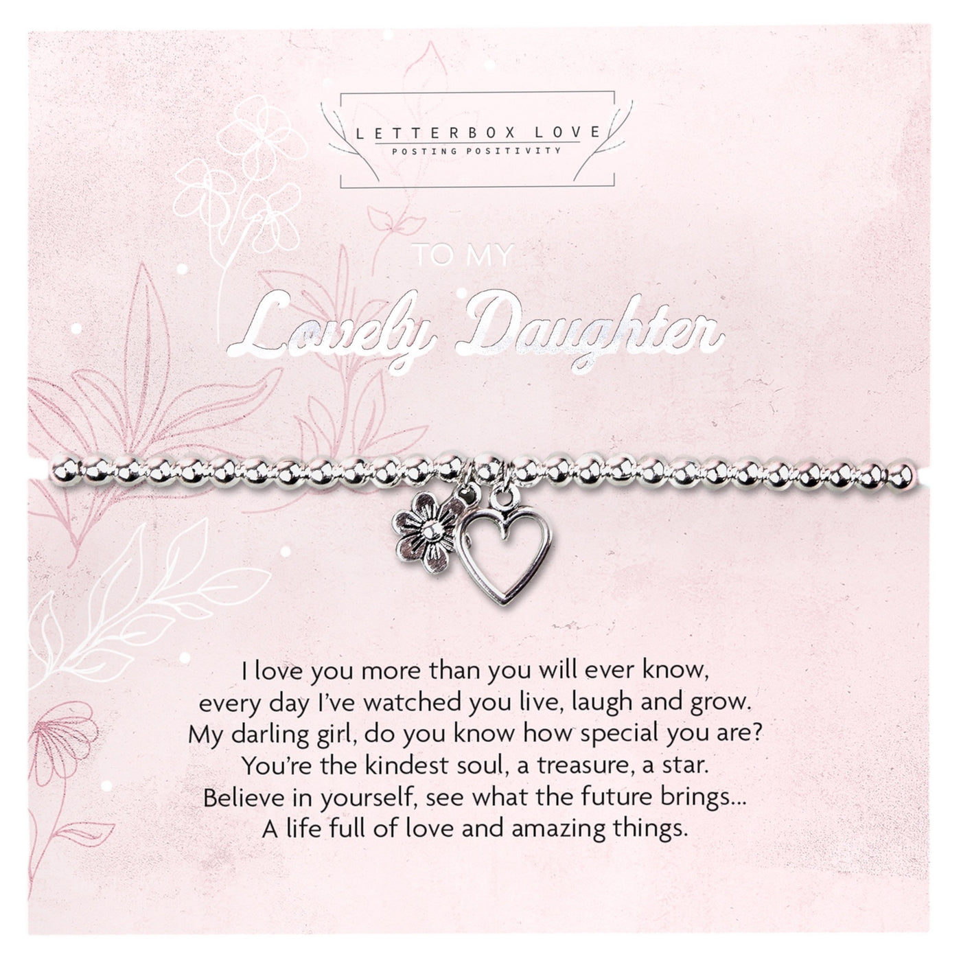 A silver beaded bracelet with a heart and flower charm displayed on a card that reads 