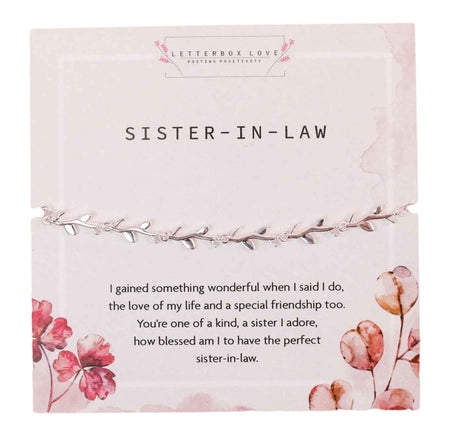 A delicate silver bracelet with leaf details, presented on a white card titled 'SISTER-IN-LAW' with pink floral accents. The card includes a heartfelt message expressing gratitude for gaining a sister and friend, celebrating a cherished sister-in-law relationship. 