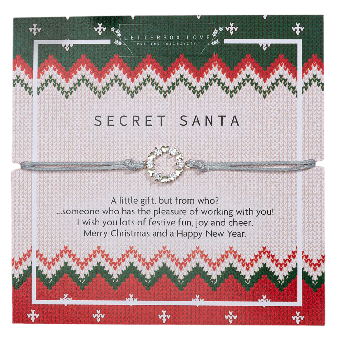A festive Secret Santa greeting card from the 'Letterbox Love' collection featuring a knitted sweater pattern design in red, white, and green. The card is wrapped with a light grey string and a decorative silver wreath charm.
