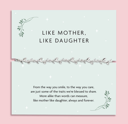 A pale pink background with a like mother like daughter poem card and silver-plated vine bracelet. A meaningful stocking filler for a daughter
