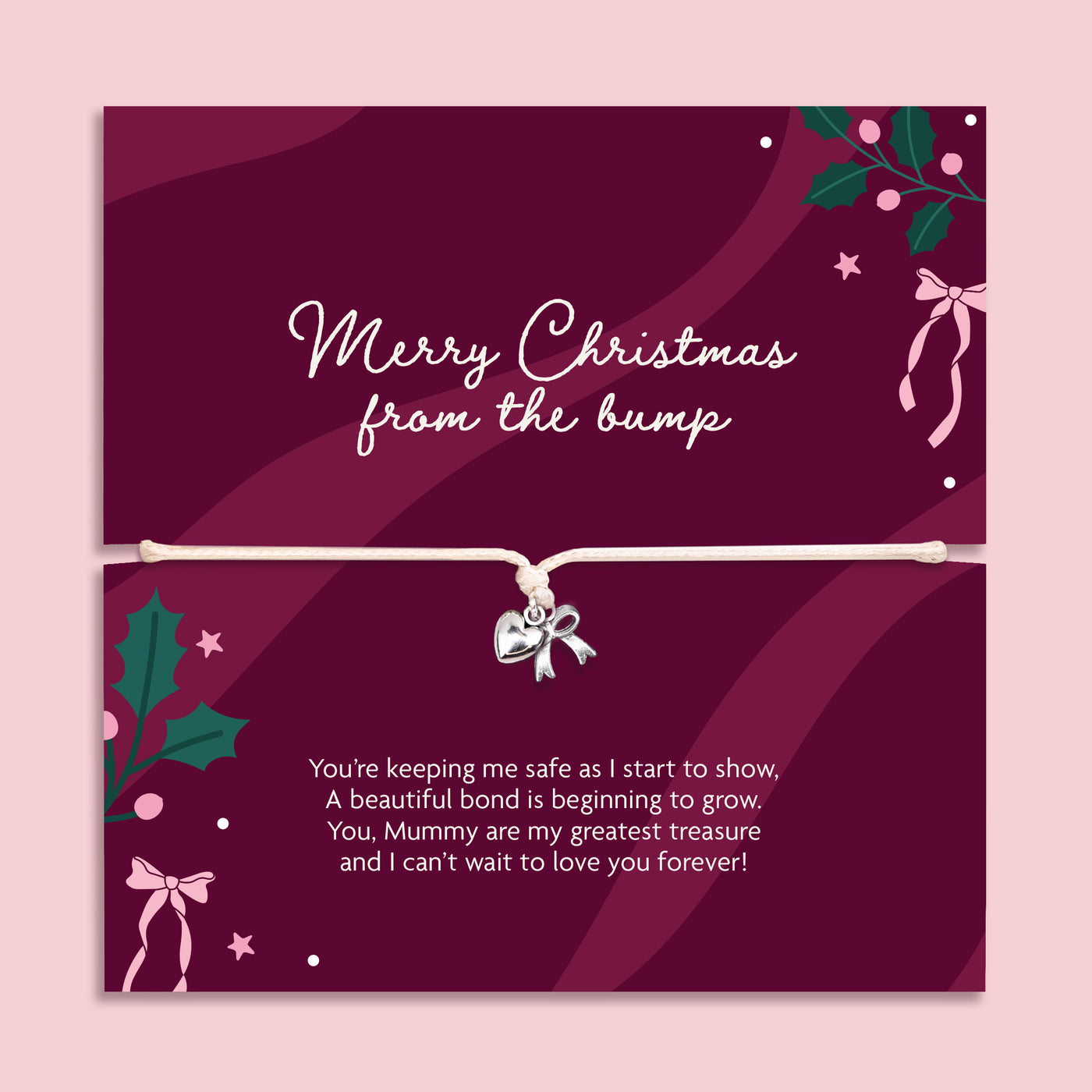 A Christmas gift with a bracelet across the center holding a small silver bow charm. The card is deep burgundy with white script text reading 'Merry Christmas from the bump' and additional holiday illustrations, shown against a light pink background.