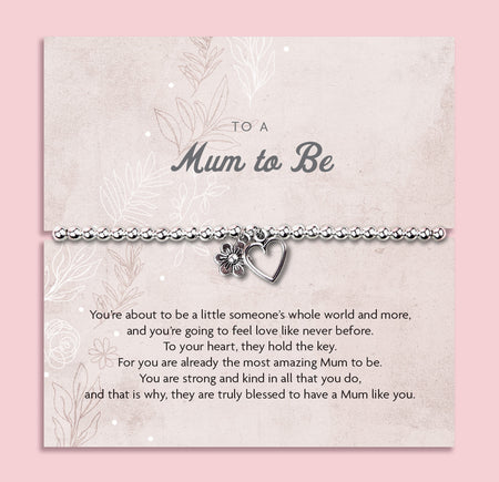 Silver beaded bracelet with heart and baby footprint charms, displayed on a sentimental card reading 