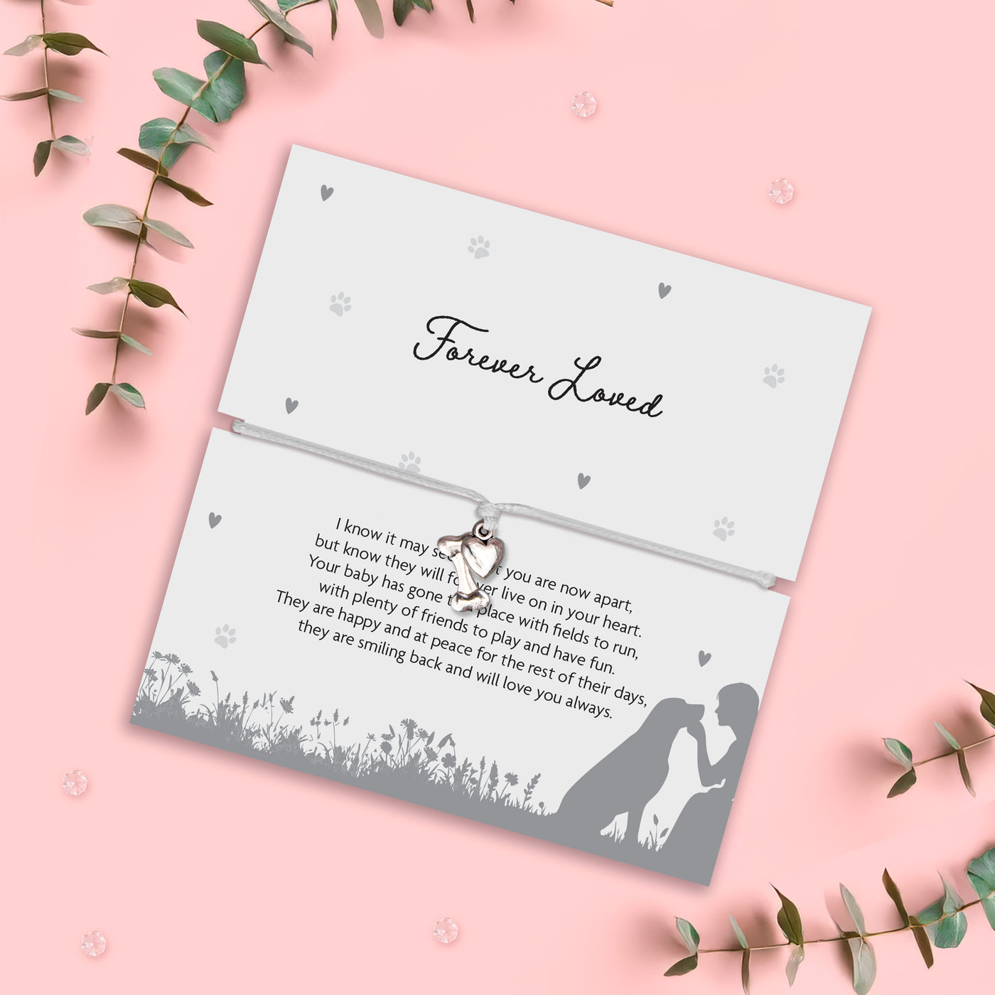 Memorial card for pet loss with text and silhouette design on a pink background