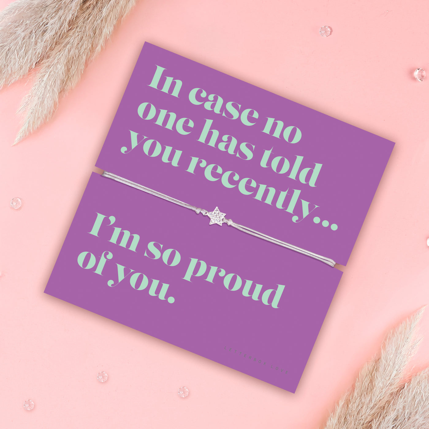 Friendship bracelet with a silver star charm on an adjustable cord, displayed on a purple card reading “In case no one has told you recently… I’m so proud of you” — an encouraging bracelet for a friend and meaningful friendship gift by Letterbox Love.
