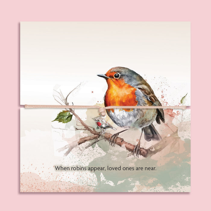 Adjustable bracelet with a silver and red enamel robin charm, displayed on a watercolour-style card featuring a robin on a branch. The card includes the phrase 'When robins appear, loved ones are near'. A thoughtful sympathy or remembrance gift from Letterbox Love.