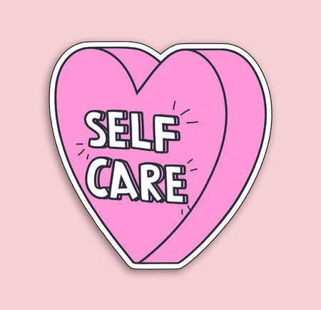 Heart-shaped sticker with 'SELF CARE' text on a pink background
