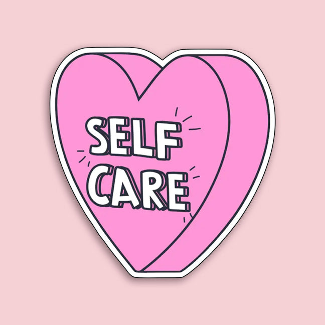 Heart-shaped sticker with 'SELF CARE' text on a pink background