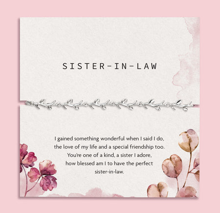 a pink background with. sister in law poem card and silver-plated bracelet for her. A meaningful bracelet gift