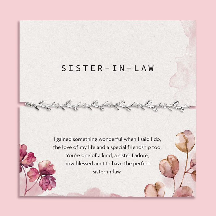 a pink background with. sister in law poem card and silver-plated bracelet for her. A meaningful bracelet gift