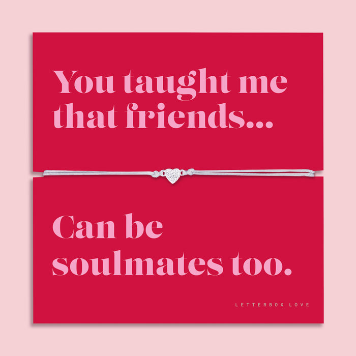 Friendship bracelet with a silver heart charm on an adjustable cord, displayed on a red card reading “You taught me that friends can be soulmates too” — a meaningful bracelet for a friend and thoughtful friendship gift by Letterbox Love.