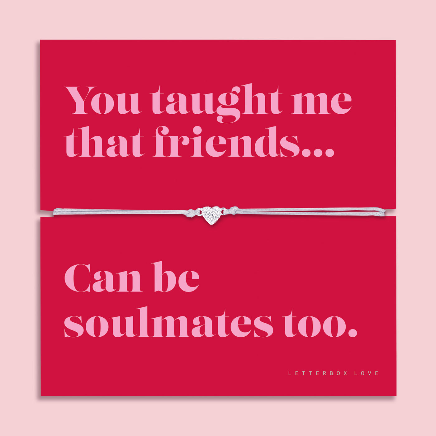 Friendship bracelet with a silver heart charm on an adjustable cord, displayed on a red card reading “You taught me that friends can be soulmates too” — a meaningful bracelet for a friend and thoughtful friendship gift by Letterbox Love.