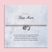 Silver beaded bracelet with a flower and heart charm, presented on a blue floral card with a heartfelt sentiment for a step mum.