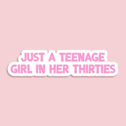 Sticker with text 'Just a teenage girl in her thirties' on a pink background