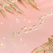 A sparkly pink background with gems and a silver star bracelet. A dainty bracelet gift for her. 