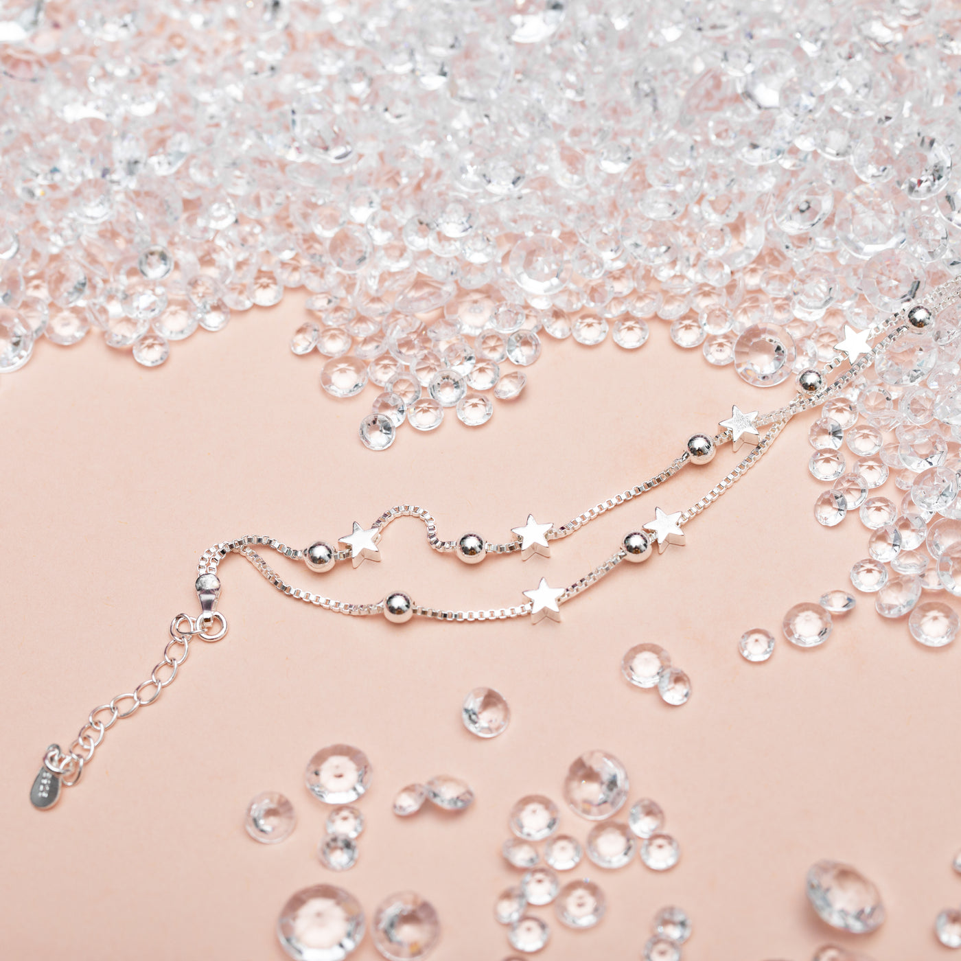 Fabulous Friend - Silver Stars Bracelet - letterboxlove. Silver star bracelet on a peach background surrounded by crystals